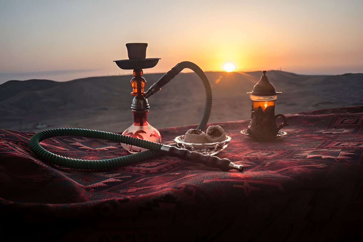 Modern and luxurious shisha setup in the Dubai desert with sleek seating, soft lighting, and sand dunes under a starry sky." @exploredesertsafari.com